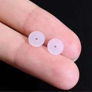 Close-up of translucent silicone earring spacers for comfort and slip resistance