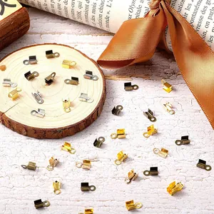 Close-up of mixed metal cord end crimp beads for DIY jewelry making and leather cord fastening