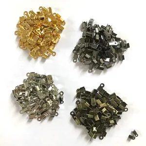 Close-up view of four sets of square metal cord end clips in multi-color finishes