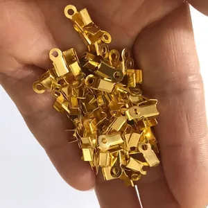 Close-up view of bulk gold-plated square crimp ends for DIY jewelry cord finishing