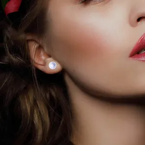 Detailed close-up showing 18K gold plated flat stud earring pin findings on a female model