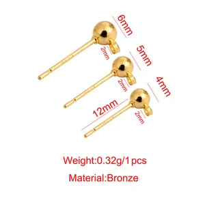 Macro view of bronze bead earring studs with hanging loops for DIY jewelry projects