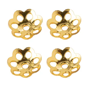 Detailed view of four 18k gold plated 6mm daisy hollow flower bead caps for DIY jewelry
