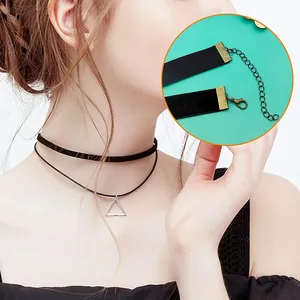Detail shot of black velvet choker with gold ribbon clamp and adjustable extension chain.
