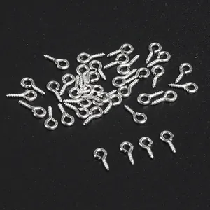 Macro view of small silver metal eye screw pins for DIY jewelry making and crafting