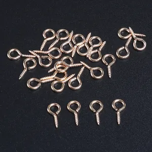 Detailed macro view of rose gold plated metallic screw eye pins for DIY jewelry crafts