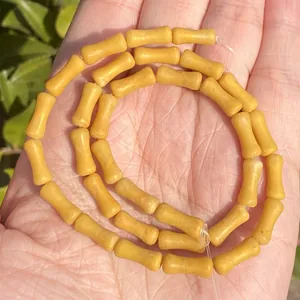 Close-up of 5x12mm yellow bamboo-shaped natural stone beads for DIY jewelry making