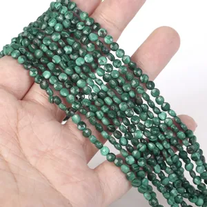 Macro detail of 4mm faceted green malachite stone spacer beads for DIY jewelry making.