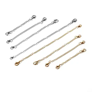 Close-up of gold and silver lobster clasp extension chains for DIY jewelry making.