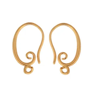 Macro view of vintage gold-plated swirl design ear hooks for DIY pearl earring jewelry making