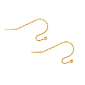 Detail view of golden French earring hooks with beads for handmade DIY jewelry.