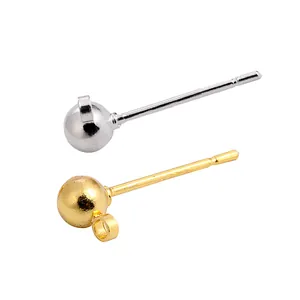 Macro detail view of gold and silver ball stud earring findings with hanging loops