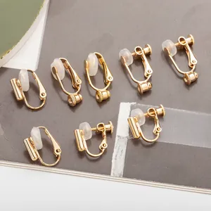 Macro detail view of gold-plated copper earring converters with screw-on and U-clip designs.