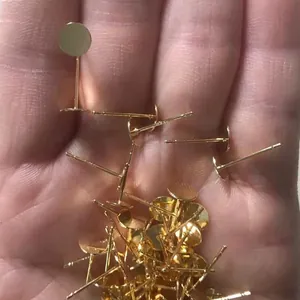 Detailed macro shot of 18k gold-plated earring posts with flat trays for DIY jewelry