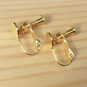 Detail view of gold-plated screw-back ear clip converters for non-pierced ears