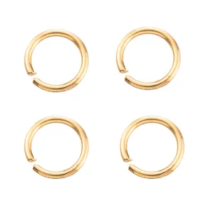 Close-up of four gold-plated copper open jump rings for jewelry making