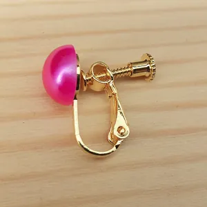 Close-up view of gold-plated copper screw-back earring converter with a pink cabochon accent
