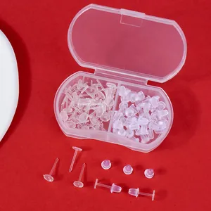 Macro view of transparent plastic earring pins and backs set inside a clear storage box