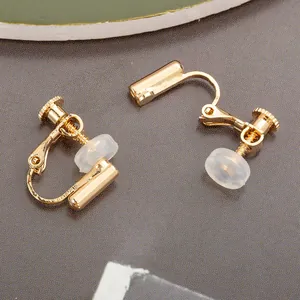 Close-up of gold screw-back earring converters for non-pierced ears with soft pads.