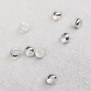 Macro detail of silver-toned silicone hamburger earring backs for DIY jewelry making