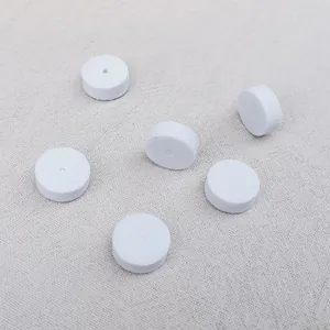 Six white circular foam jewelry gaskets for protecting earring needles and packaging