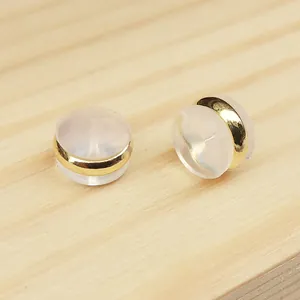 Macro detail view of gold-plated silicone hamburger earring backs for DIY jewelry crafting