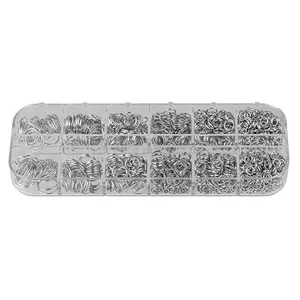 Detailed view showing various sizes of silver open jump rings in a storage box