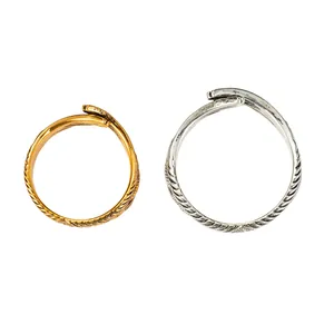 Macro detail of gold and silver vintage angel wing rings with adjustable bands.