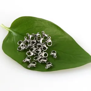 Close-up of 304L stainless steel lobster clasps on a green leaf for DIY jewelry.