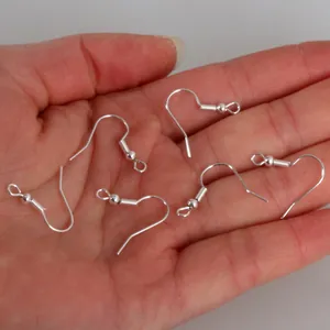 Premium silver plated French fish earring hooks for DIY jewelry making held in hand
