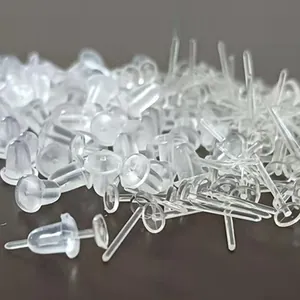 Macro detail of transparent plastic earring posts and backs for DIY jewelry making.