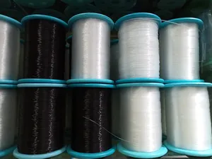 Close-up of black and transparent elastic beading thread spools for jewelry making