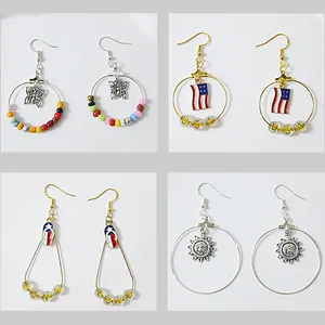 Detail view of assorted DIY hoop earring accessories with various charms and colorful beads