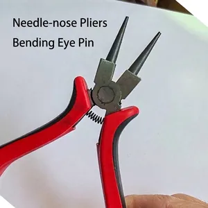 Detail of red needle-nose pliers for DIY jewelry making and bending eye pins