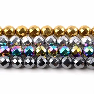 Close-up detail of faceted metallic hematite beads in gold, silver, and rainbow finishes