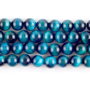 Close-up detail of natural royal blue tiger eye round beads showing unique stone texture.