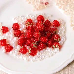 Detailed view of handmade red berry glass beads and white pearls for DIY jewelry crafts