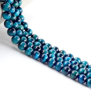 Detailed view of polished blue tiger eye beads showing natural chatoyancy and texture.