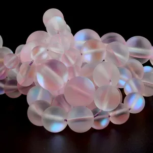 Close-up of frosted pink aurora beads showing soft opalescent glow for DIY jewelry.