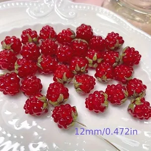 Close-up of red handmade textured raspberry glass beads for DIY jewelry making