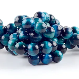 Close-up of premium natural royal blue tiger eye round loose beads for DIY jewelry making