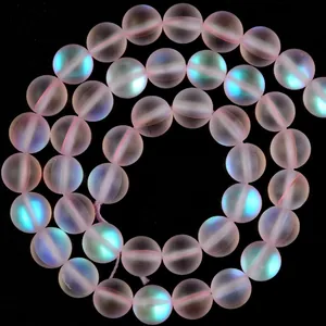 Close-up of frosted pink aura round beads with iridescent mermaid glow.