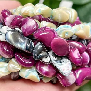 Detailed close-up showing the lustrous texture of multi-color irregular shell beads