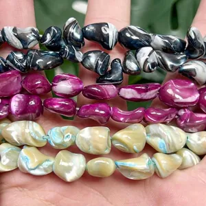 Macro view of irregular shell beads with swirling patterns for DIY jewelry making