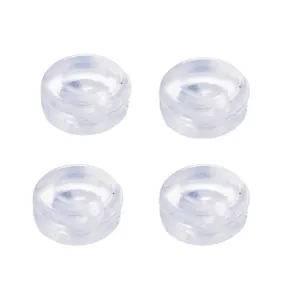 Detailed view of four transparent round silicone comfort pads for clip-on earrings