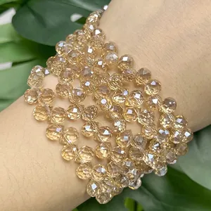 Macro detail of amber faceted crystal beads wrapped around a wrist showing sparkle