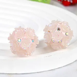 Macro detail of pink resin camellia beads with rhinestones for DIY jewelry