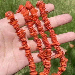 Macro view of vibrant orange fragmented shell beads for handmade DIY jewelry.