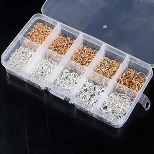 Detailed view of various sized silver and gold jump rings in a 10-slot organizer box.