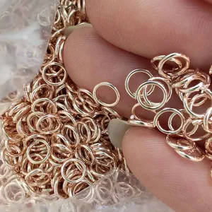 Close-up of rose gold open jump rings for DIY jewelry making and handmade crafts